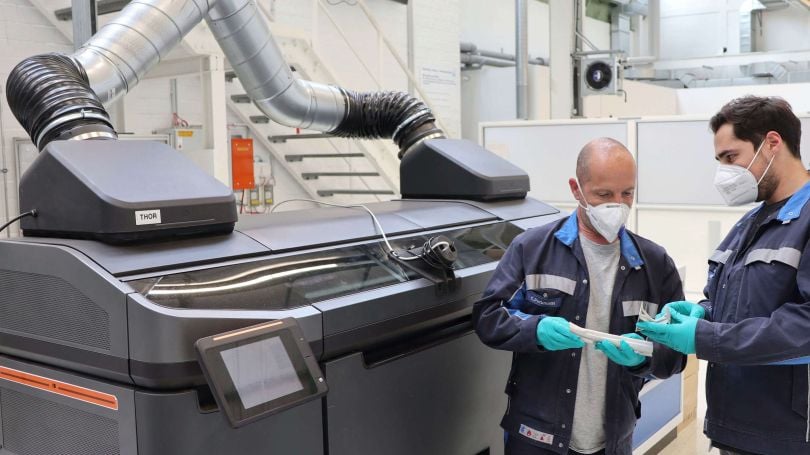 Volkswagen employees checking parts made using binder jetting process